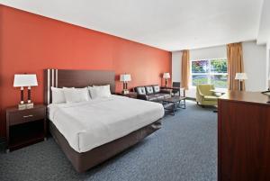 a large hotel room with a bed and a desk at River Lodge and Cabins in Boardman +34 photos