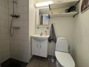 a bathroom with a sink and a toilet and a mirror at Kongensgate Apartments in Kristiansand +58 photos