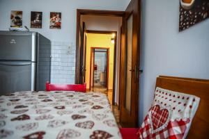 a kitchen with a bed and a refrigerator at Casa Gabry - your first step in the Dolomites in Belluno