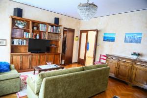 a living room with a couch and a tv at Casa Gabry - your first step in the Dolomites in Belluno