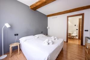 a bedroom with a large white bed with white pillows at Emilia Studios 8 in Modena