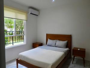 a bedroom with a bed and a window at NEW! Jungle Chic Retreat in Aldea Tulum in Tulum +45 photos