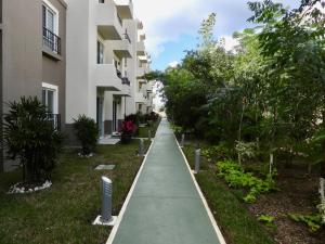 a sidewalk in front of a apartment building at NEW! Jungle Chic Retreat in Aldea Tulum in Tulum