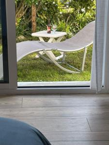 a table and a chair outside a sliding glass door at La Chambre Bleue in Quimper