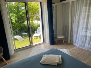 a bedroom with a bed and a large sliding glass door at La Chambre Bleue in Quimper