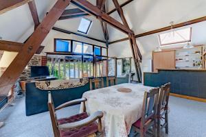a kitchen and dining room with a table and chairs at Le Sud in Saint-Priest-sous-Aixe