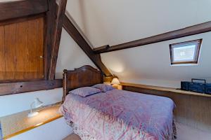 a bedroom with a bed in the corner of a room at Le Sud in Saint-Priest-sous-Aixe +9 photos