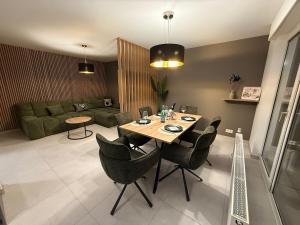 a living room with a table and chairs at Mountain Lodge - Design Apartment in Winterberg +8 photos