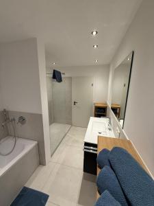 a bathroom with a bath tub and a sink and a bath tub at Mountain Lodge - Design Apartment in Winterberg