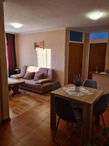 a living room with a table and a couch at Apartmani Viola in Momjan