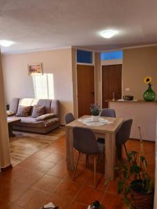 a living room with a table and a couch at Apartmani Viola in Momjan +21 photos