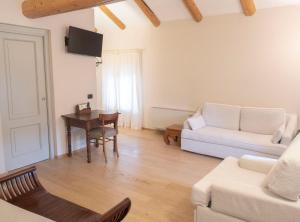 a living room with a couch and a table at B&B Fior Di Farine in La Morra