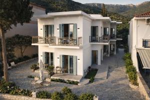 an aerial view of a white house with a balcony at Okeanis Hotel Tyros in Tyros
