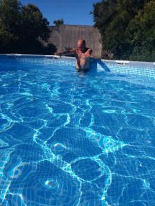 a woman in a swimming pool at Cabaña Óga Pora' in Puerto Yeruá