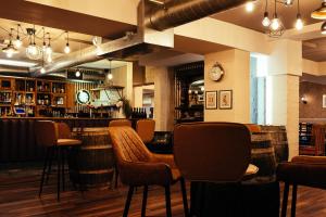 a bar with chairs and a counter in a restaurant at The Duke of Edinburgh Hotel & Bar in Barrow in Furness