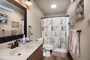 a bathroom with a sink and a toilet and a shower at Pineview Cabin Retreat in the Black Hills- 4 bed, 2 bath in Sturgis +15 photos