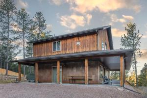a wooden house with a black roof at Pineview Cabin Retreat in the Black Hills- 4 bed, 2 bath in Sturgis