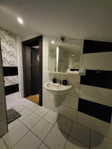 a bathroom with a sink and a mirror at Kryształowa poddasze in Józefów +39 photos