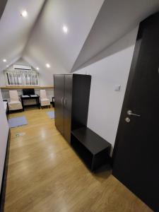 a room with a black door and a table and chairs at Kryształowa poddasze in Józefów