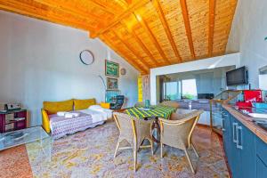 a living room with a couch and a table and chairs at B&B Al Cristo in SantʼAmbrogio di Valpolicella
