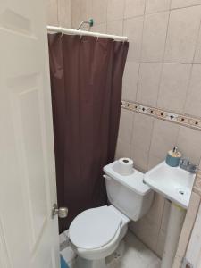 a bathroom with a toilet and a sink at Casa Ixtapa in Ixtapa +2 photos