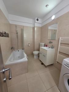 a bathroom with a tub and a toilet and a sink at City Premium Apartments in Timişoara +20 photos