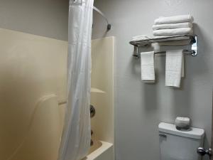 a bathroom with a shower and a toilet with towels at Quality Inn Neosho in Neosho +77 photos