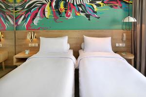 Voodi või voodid majutusasutuse Ibis Styles Bogor Raya toas