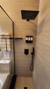 a bathroom with a toilet and a sink and towels at Pop Art Loft in Hialeah +4 photos