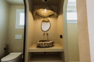 a bathroom with a sink and a mirror at Maria's place boutique hotel in Antiparos