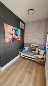 a living room with a couch and a painting on the wall at Pop Art Loft in Hialeah