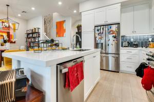 a kitchen with white cabinets and a red towel at 12 Mi to DTLA! Multi-Level Charmer w/ Pool Access in Montebello