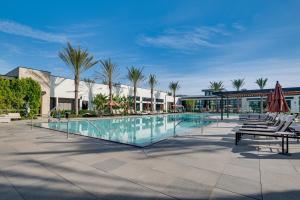 a large swimming pool with chairs and umbrellas at 12 Mi to DTLA! Multi-Level Charmer w/ Pool Access in Montebello