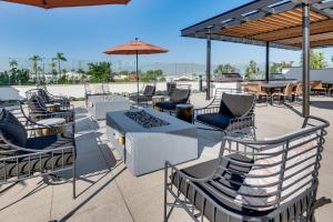 a patio with chairs and tables and umbrellas at 12 Mi to DTLA! Multi-Level Charmer w/ Pool Access in Montebello