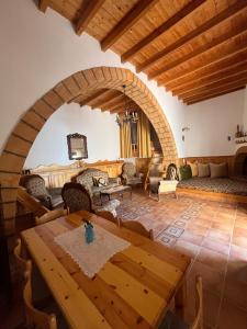 a large living room with a wooden table and chairs at Traditional Stay in Archangelos