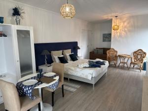 a bedroom with a bed and a table and chairs at Casa Caloura Ocean Deluxe Accommodation & Spa in Lagoa +53 photos