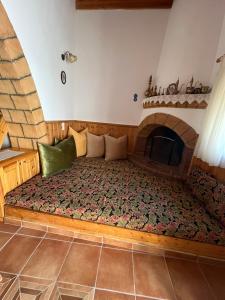 a bed in a room with a fireplace at Traditional Stay in Archangelos