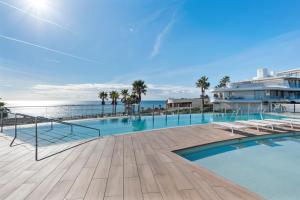 a swimming pool with a view of the ocean at Casa Costa Tropical in Estepona