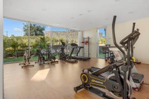 a gym with several treadmills and exercise bikes at Casa Costa Tropical in Estepona