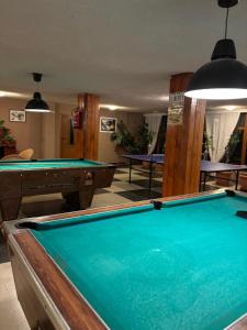 a billiard room with a pool table and tables at Парк-хотел Родопи in Churen
