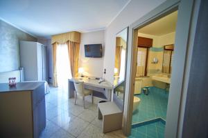 a bathroom with a desk and a sink and a tub at Le 2 Palme Apartments in Catanzaro Lido +58 photos