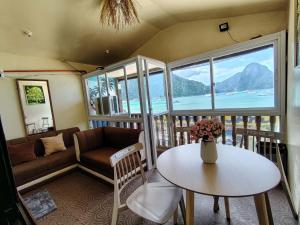 a living room with a couch and a table at Gracias Place in El Nido