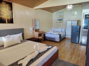 a hotel room with a bed and a couch at Gracias Place in El Nido