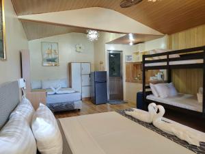 a living room with a bunk bed and a kitchen at Gracias Place in El Nido