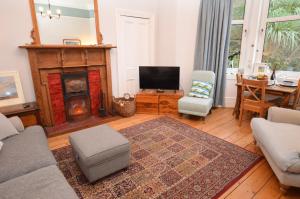 a living room with a fireplace and a tv at Montford Shore in Rothesay