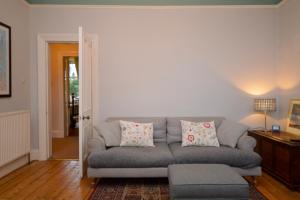a living room with a gray couch and a table at Montford Shore in Rothesay