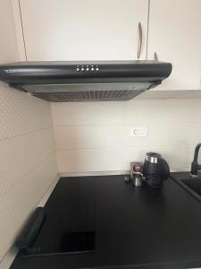 a kitchen with a black counter top with a stove at Zenith Apartment - Herceg Novi & Beach & Private Parking in Bijela +10 photos