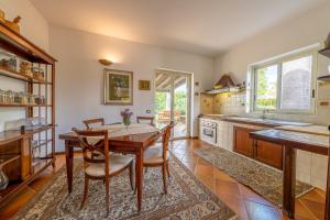a kitchen with a wooden table and chairs at Villa Carlotta Resort in San Leone