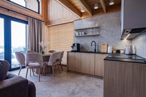 a kitchen with a table and chairs in a room at Góralska Dolina II Jacuzzi & Sauna in Zakopane