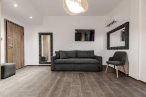 a living room with a couch and two chairs at Ermou Residences in Volos +110 photos